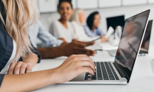 blonde-woman-with-elegant-hairstyle-typing-text-keyboard-office-indoor-portrait-international-employees-with-secretary-using-laptop
