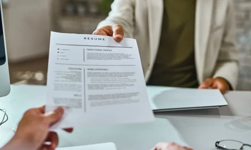 closeup-job-applicant-giving-his-resume-job-interview-office